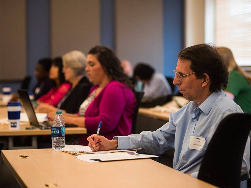 people at desks in conference