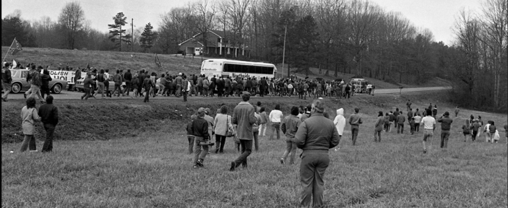 Black and white photo of large group marching